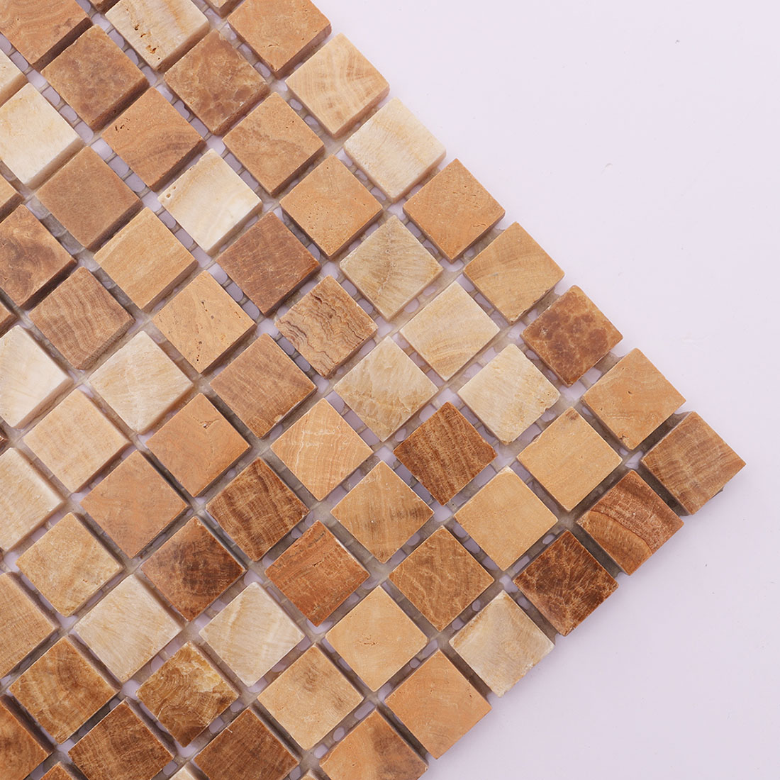 Corner detail of beige brown square marble mosaic tile with warm natural variation