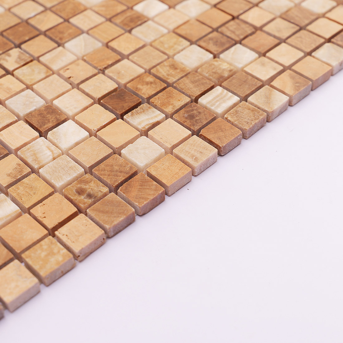 Side edge of beige brown square marble mosaic tile with varied natural tones