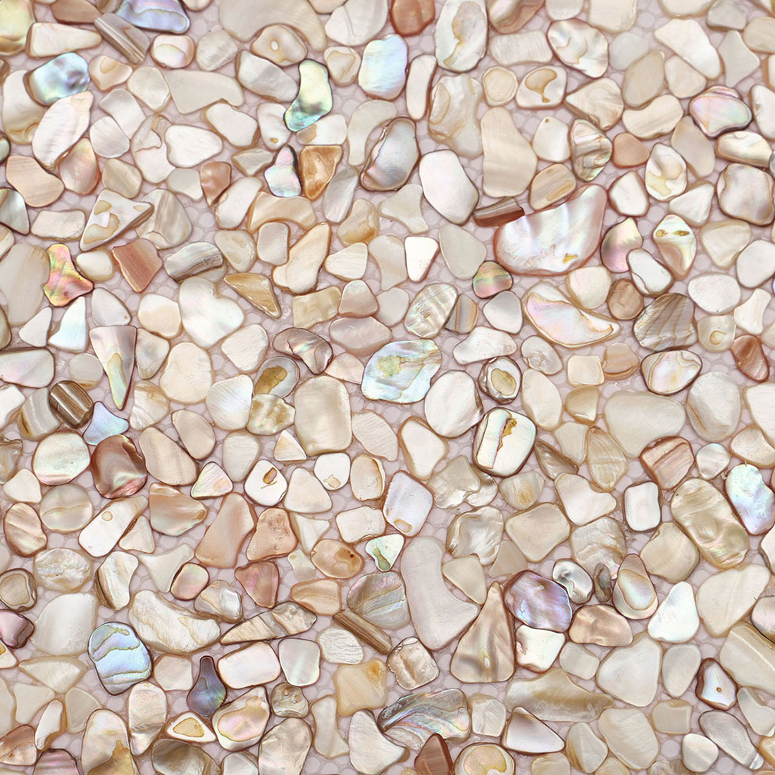 Close up of beige iridescent mother of pearl pebble mosaic tile surface texture
