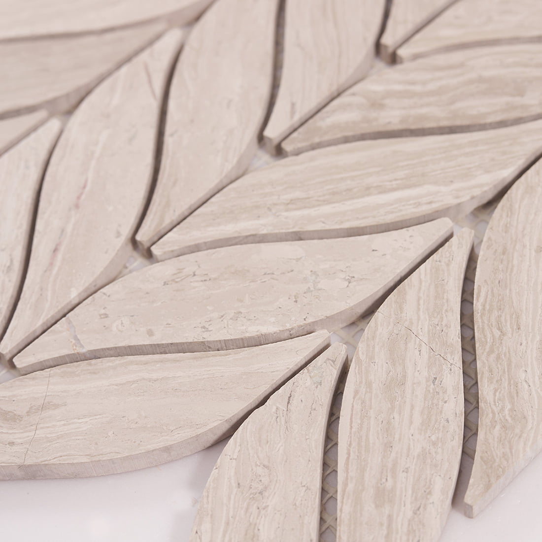 Side close up of beige marble leaf mosaic highlighting stone edge profile.