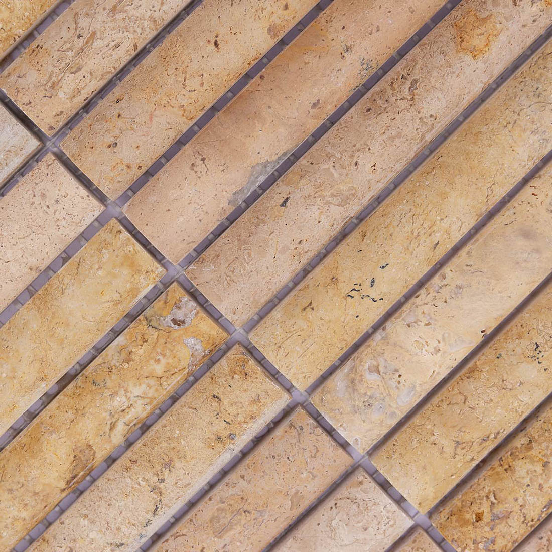 Beige travertine mosaic strips with natural fossil patterns and brown markings