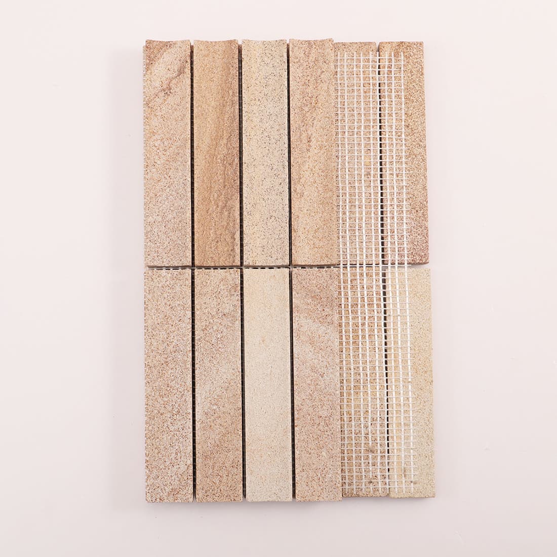 Back view of beige stone linear mosaic sheet showing mesh backing on white background