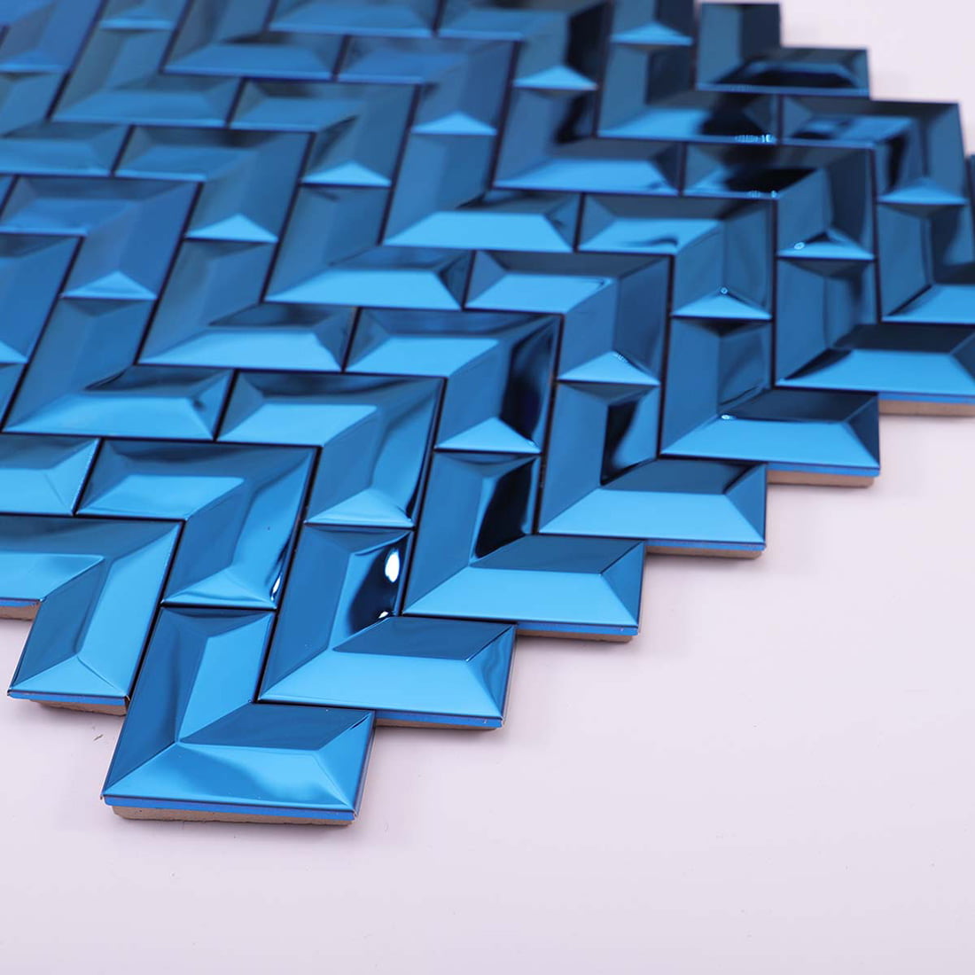 Angled perspective view showing the beveled 3D texture of blue V-shape metal tiles.