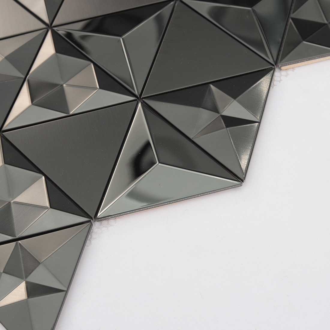 Edge detail of black 3D triangle metal mosaic with raised geometric surface