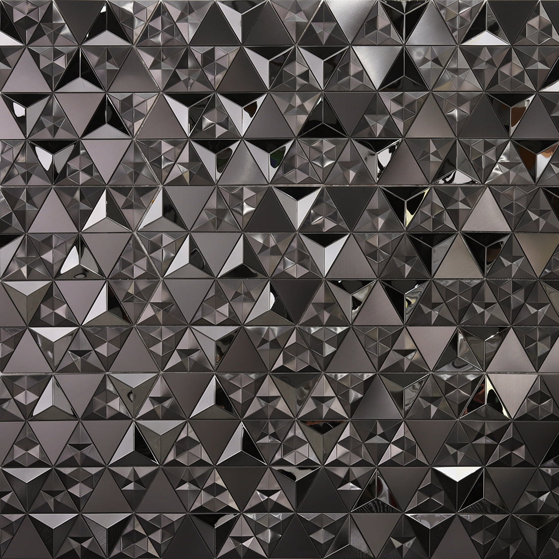Close-up of black triangle mosaic wall with brushed and glossy 3D metal facets