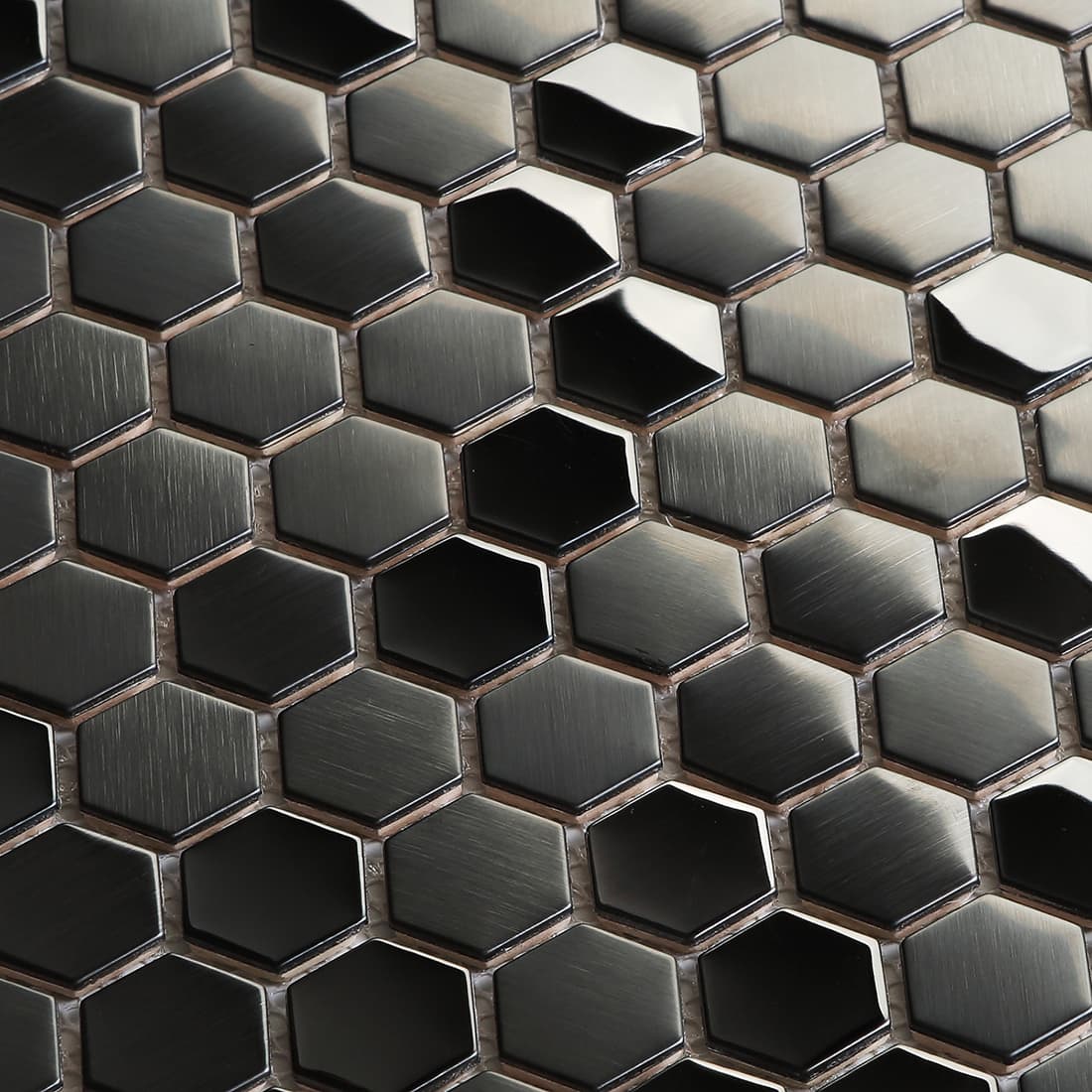 Detailed texture of black brushed stainless steel hexagons with light and shadow.