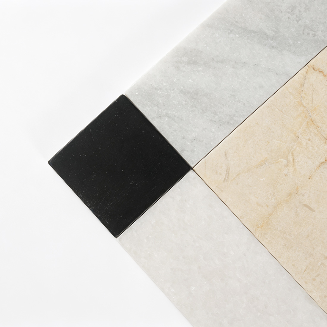 Close-up of black corner accent with white and beige marble border tile