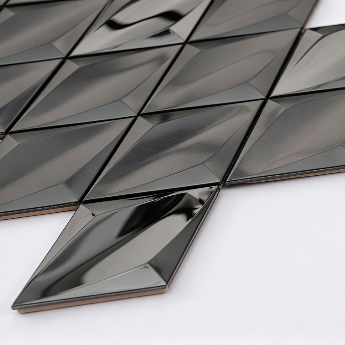 Angled view of black diamond metal mosaic tile sheet edge