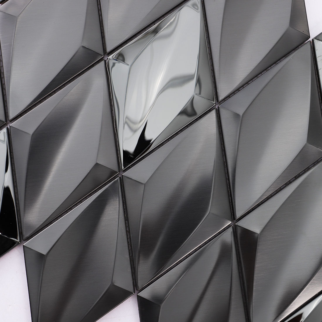 Close-up of black diamond metal mosaic tile with faceted surfaces