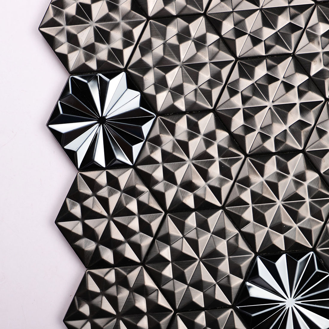 Black geometric metal mosaic tile detail with dimensional hexagonal chips