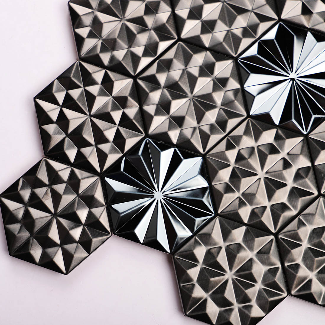 Detailed texture of black faceted geometric metal mosaic tiles