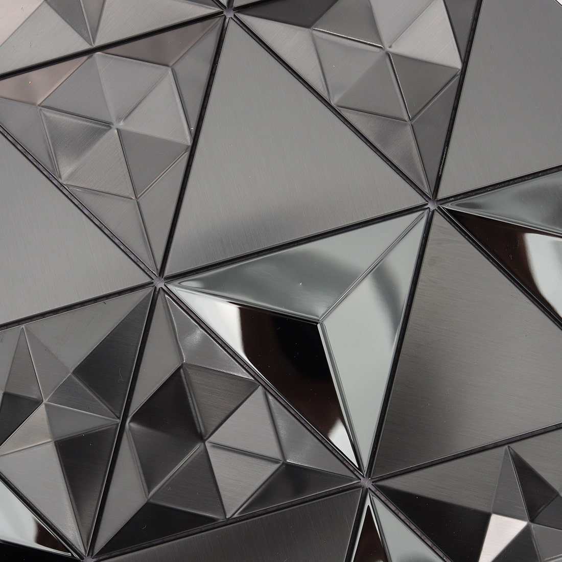 Close-up of black triangle mosaic with glossy mirror and brushed metal textures