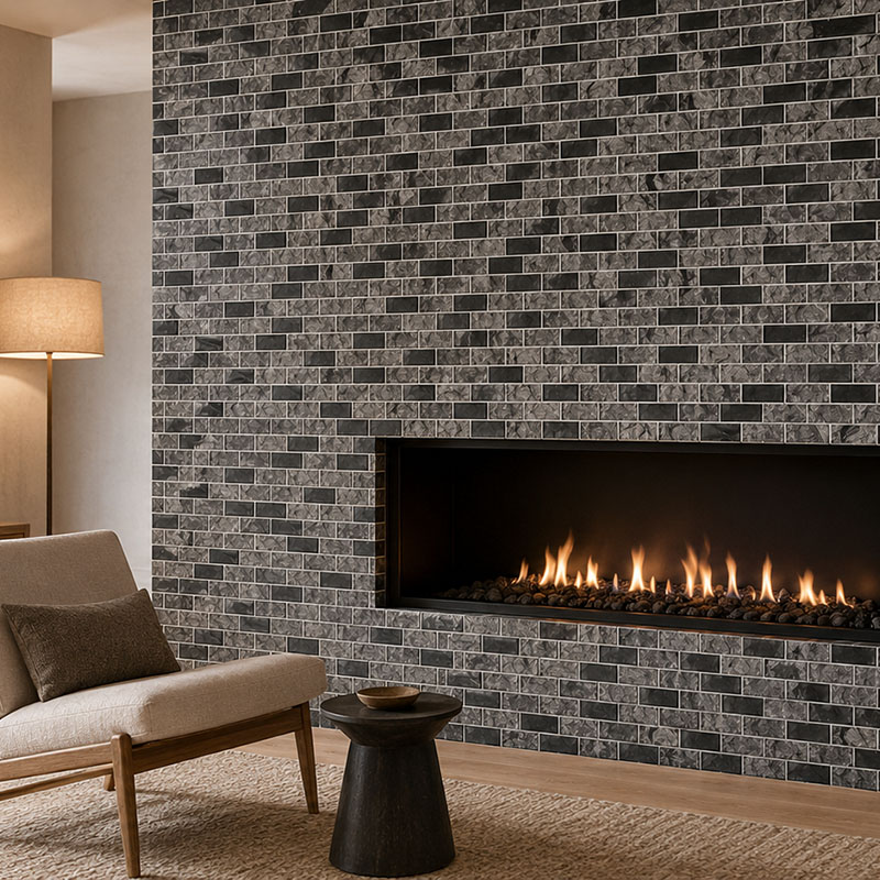 Close-up of a black and gray subway tile fireplace with white grout