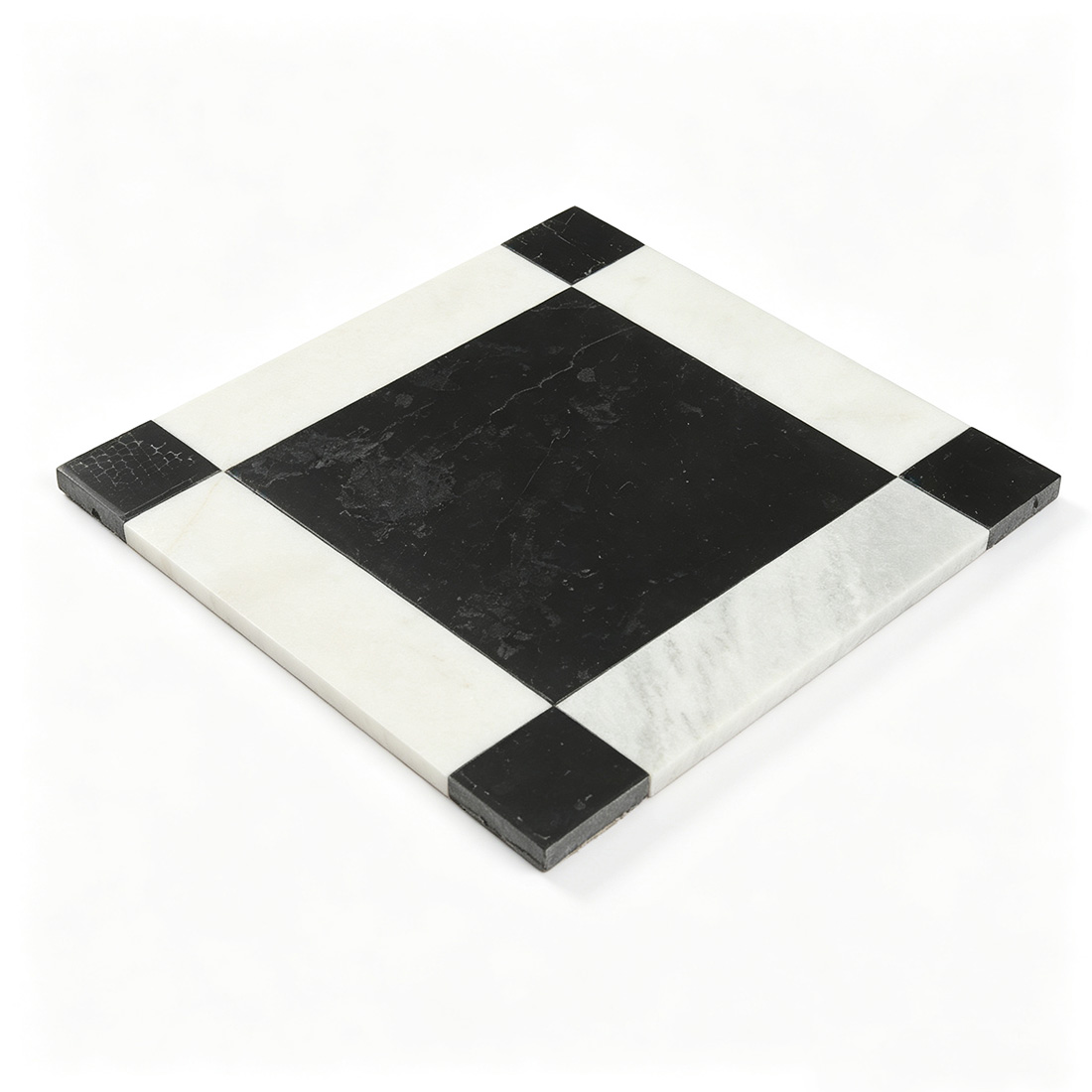Angled view of black marble floor tile with white border and black corner accents