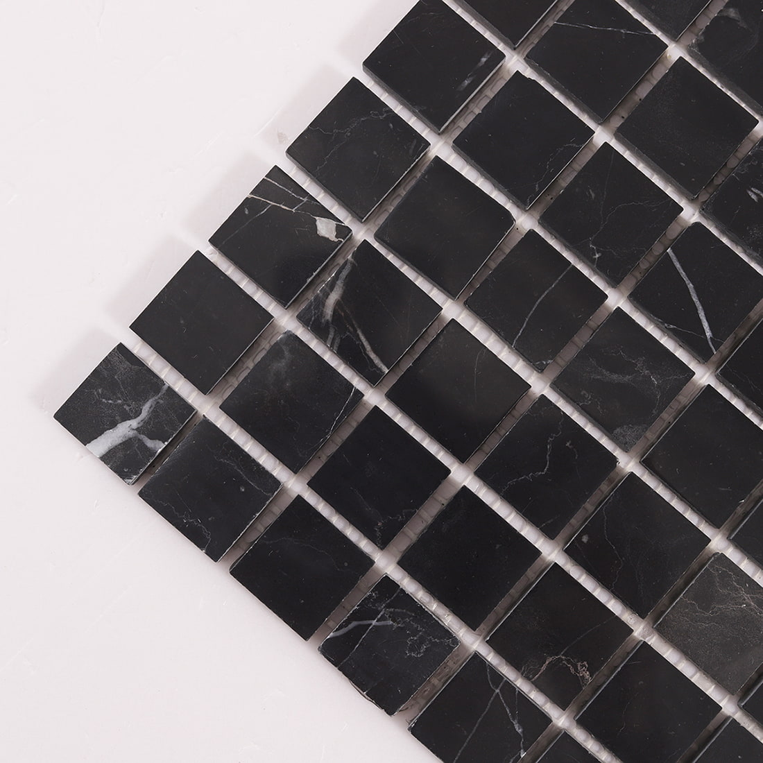 Close up detail of black marble mosaic tile with square pieces