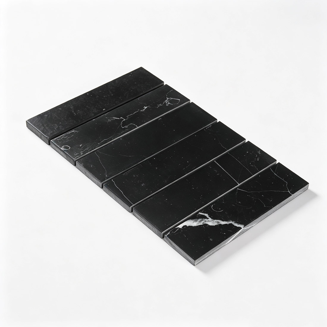 Angled view of black marble wide bar mosaic tile sheet