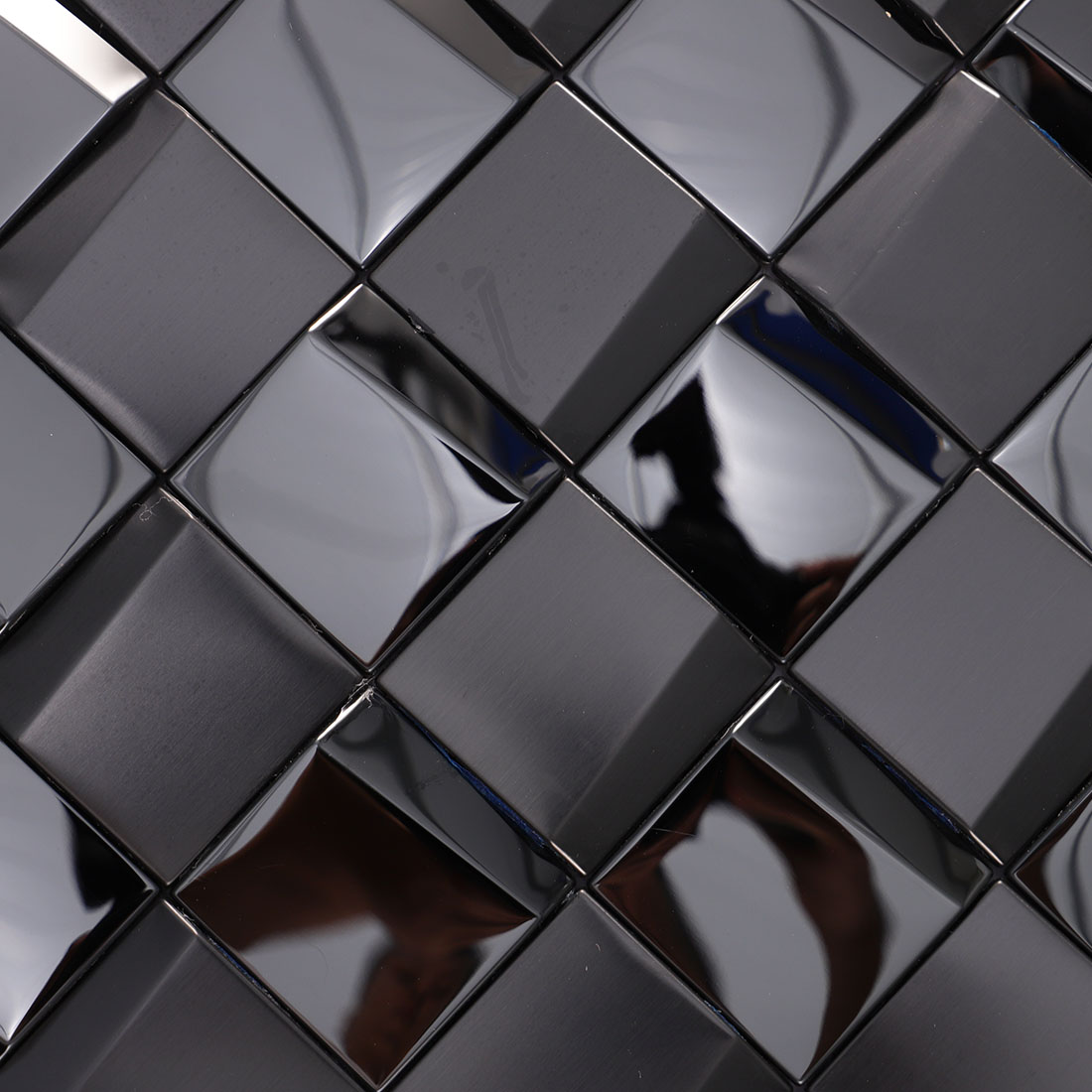 Close-up of black square metal mosaic tile with glossy and brushed surfaces