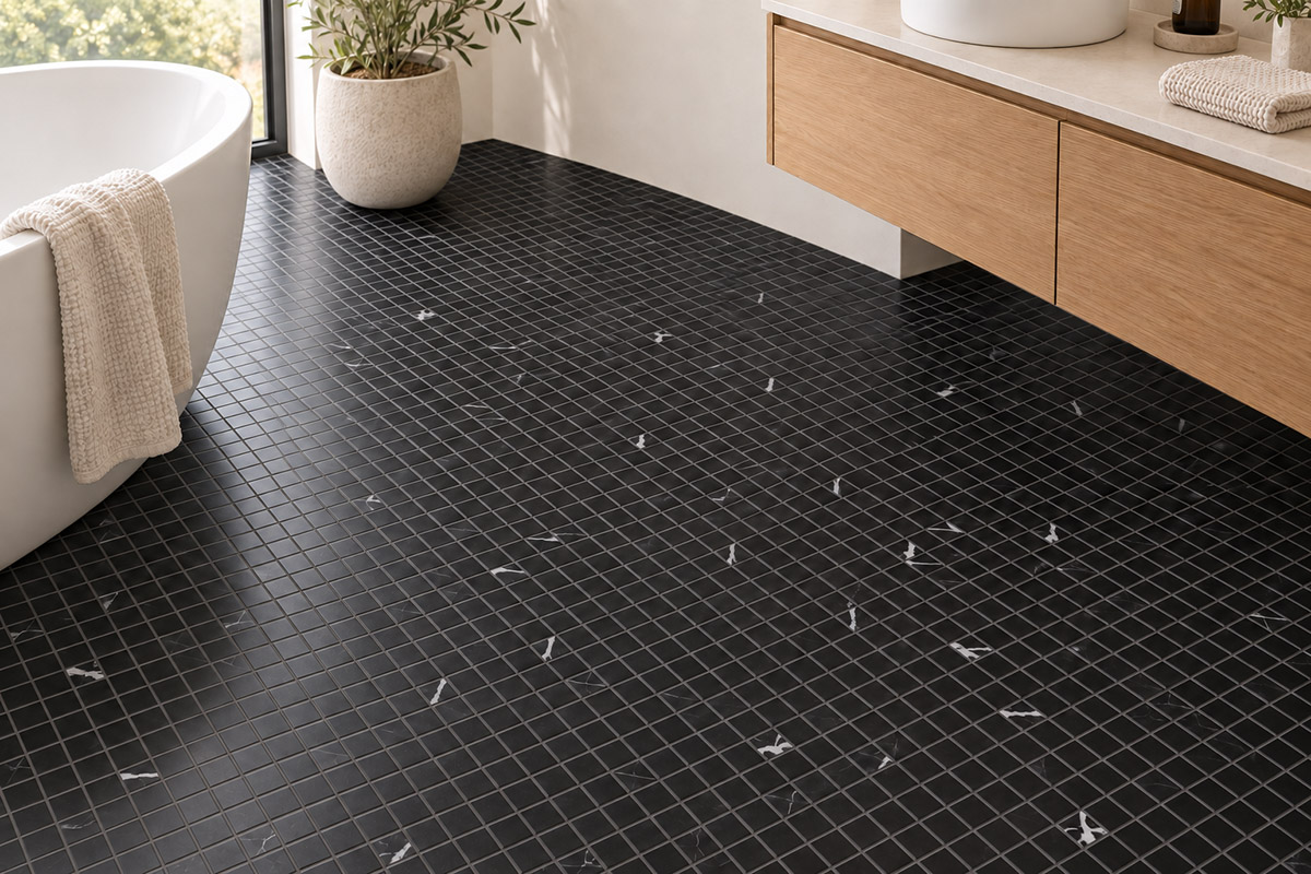 Black square mosaic tile floor in a modern bathroom with a bathtub and wood vanity