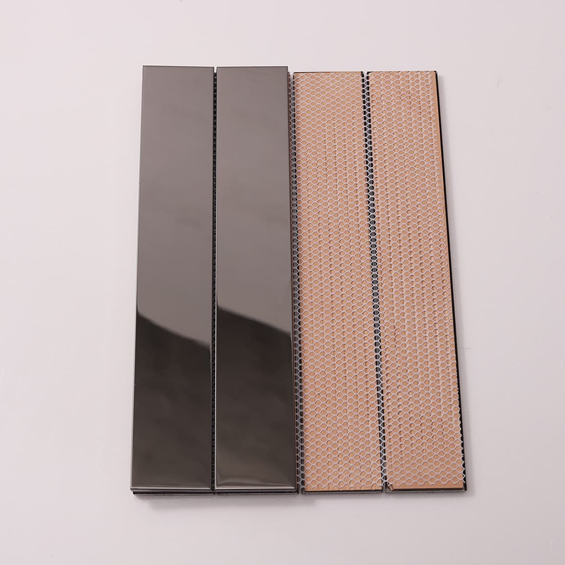Front and back view of black strip tiles showing the fiber mesh backing.