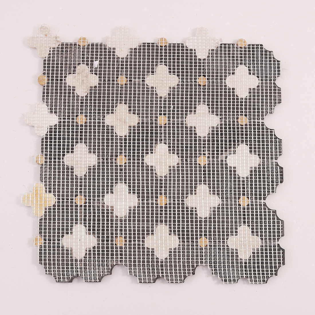 Back view of clover mosaic sheet with mesh backing for easy installation