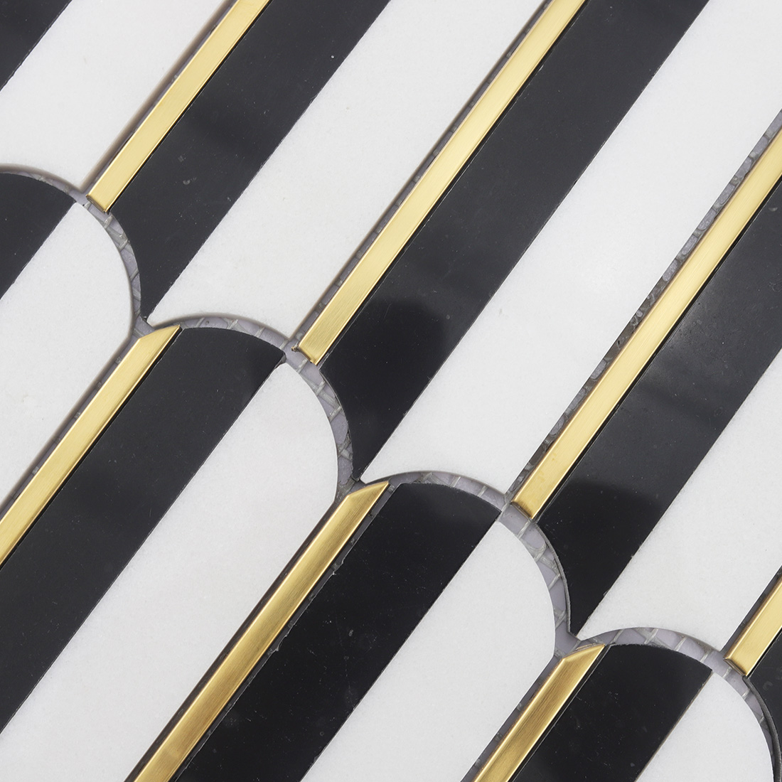 Detailed view of black white rounded mosaic pattern with gold lines