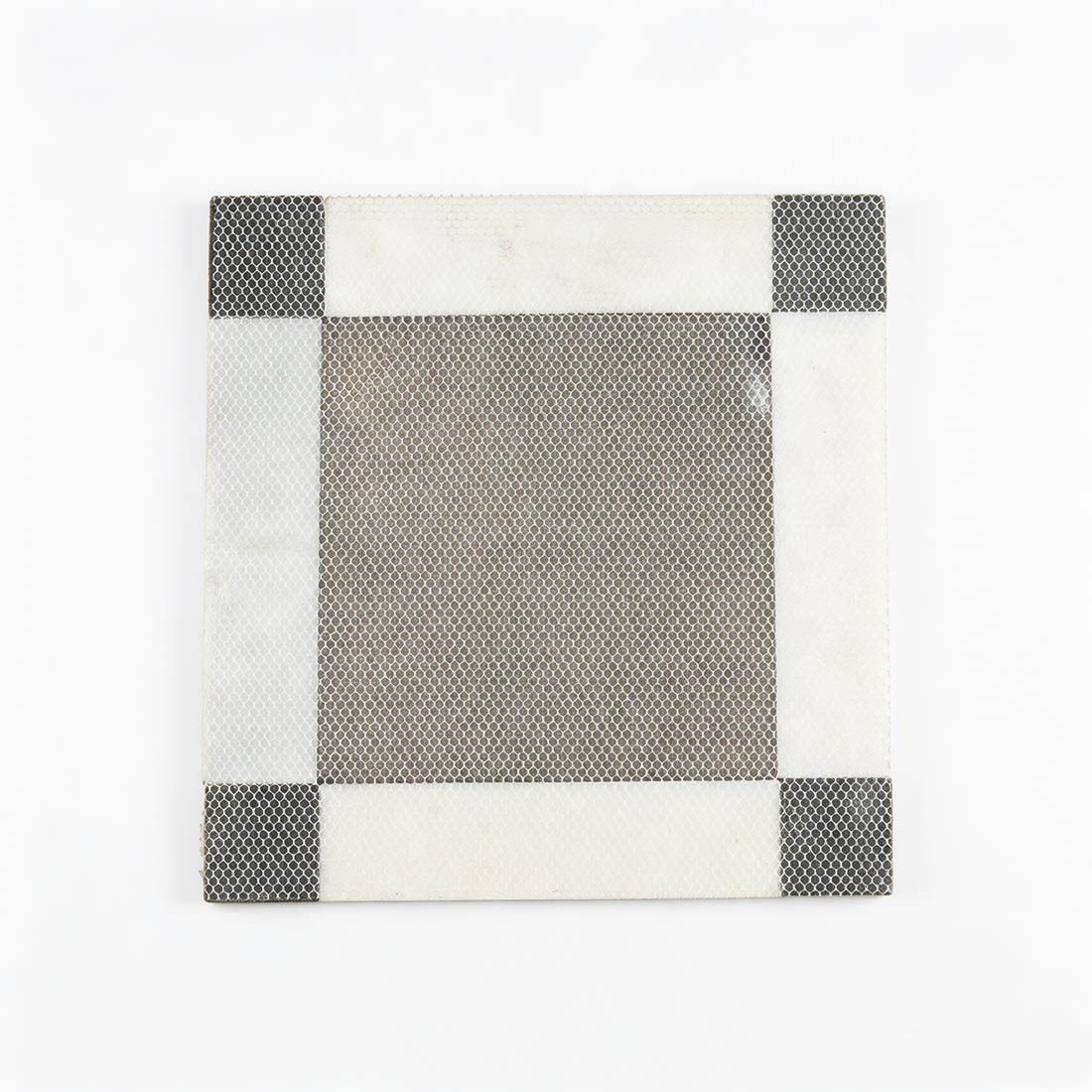 Mesh-backed black marble floor tile with white border and black corner accents
