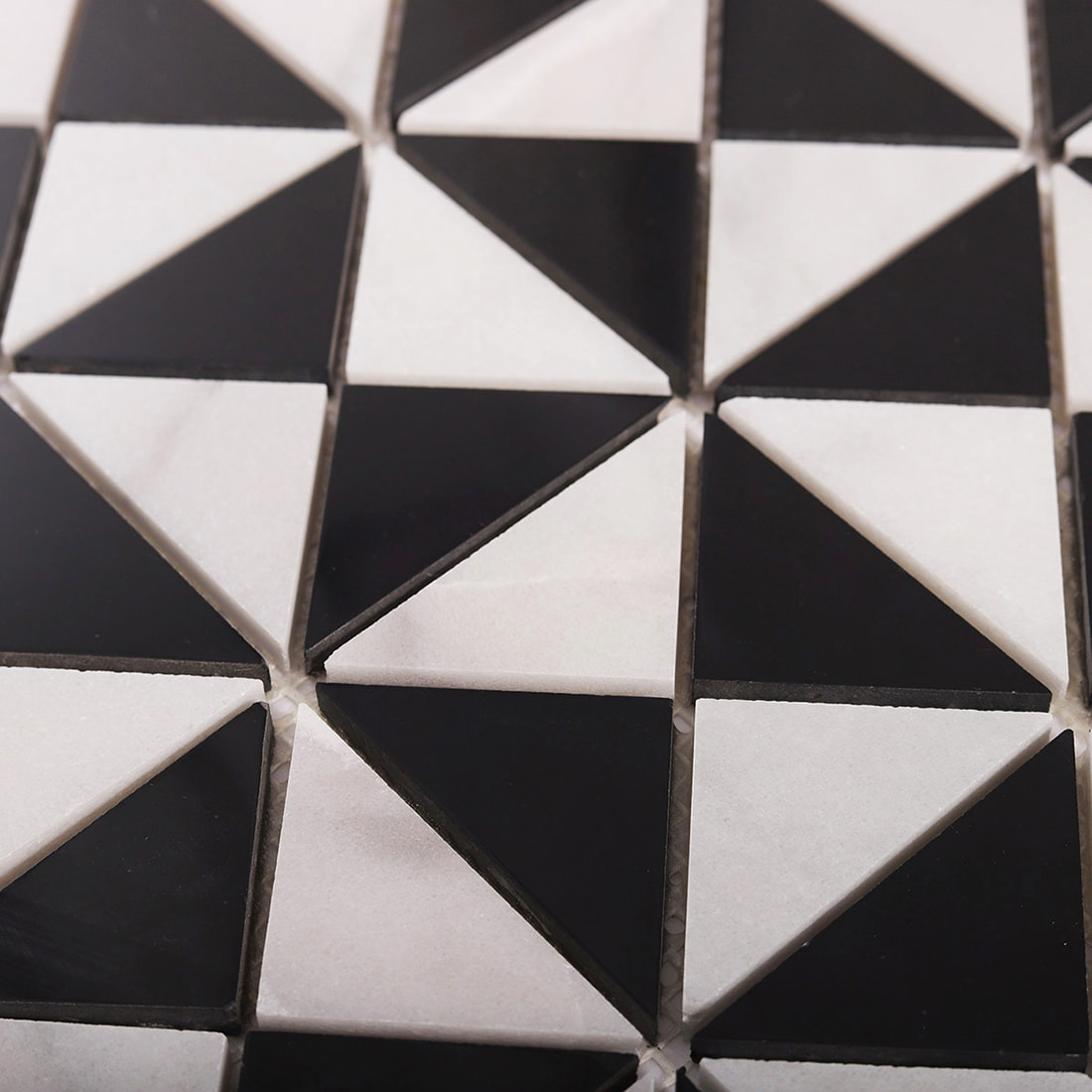 Angled close up of triangle mosaic showing raised edges and glossy black pieces