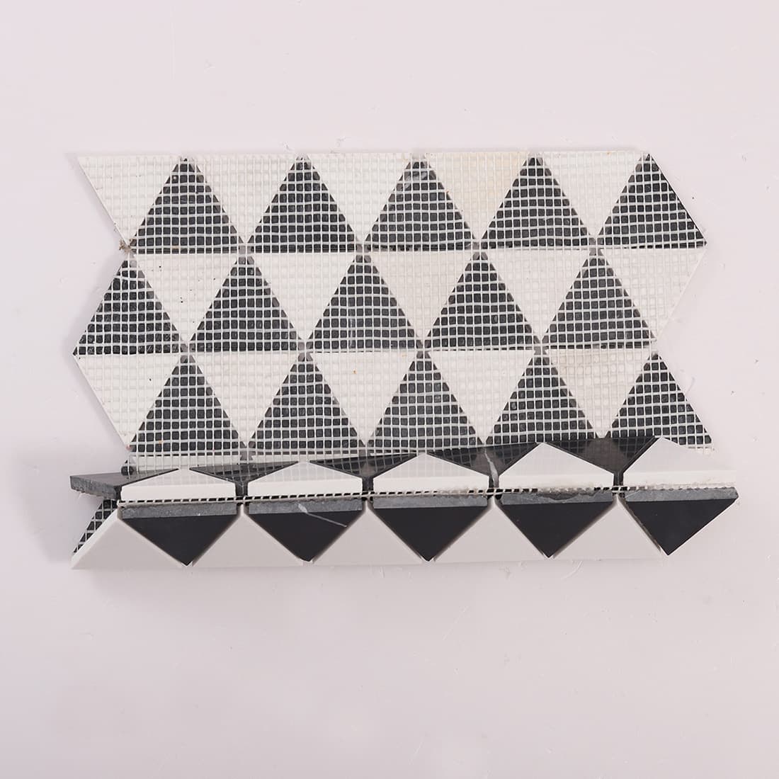 Back view of black and white triangle marble mosaic sheet with fiberglass mesh