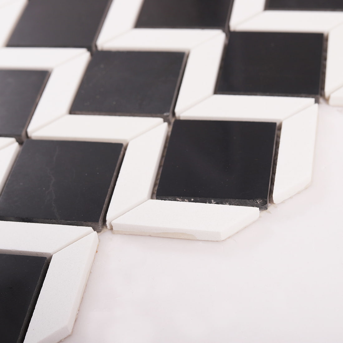 Side view showing thickness of black and white marble mosaic tile