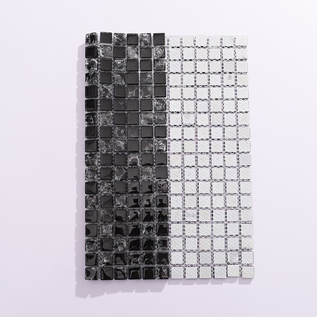Black crystal glass mosaic sheet folded to show front surface and mesh backing
