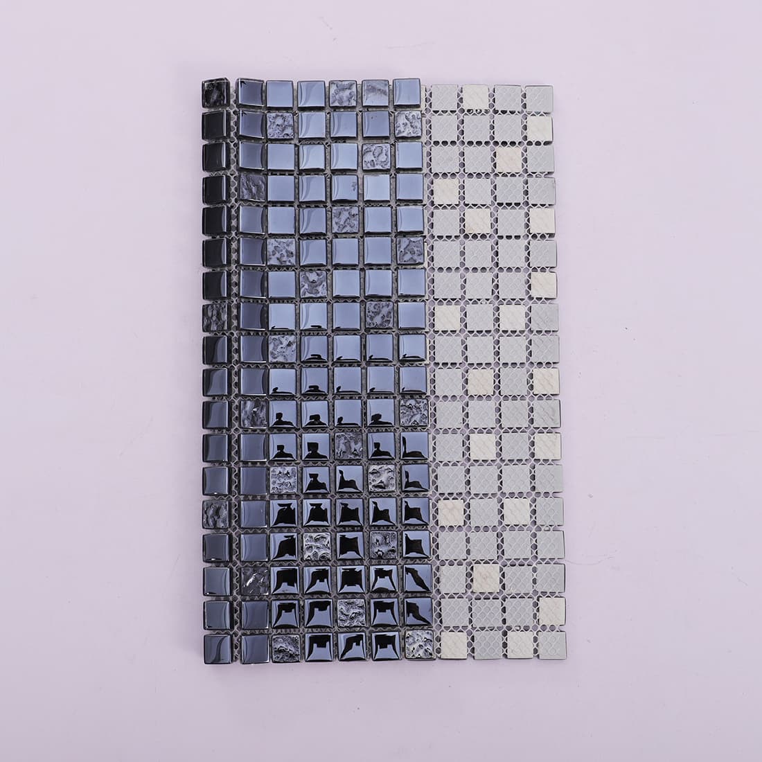 Black and gray square glass mosaic sheet folded to show front and mesh backing