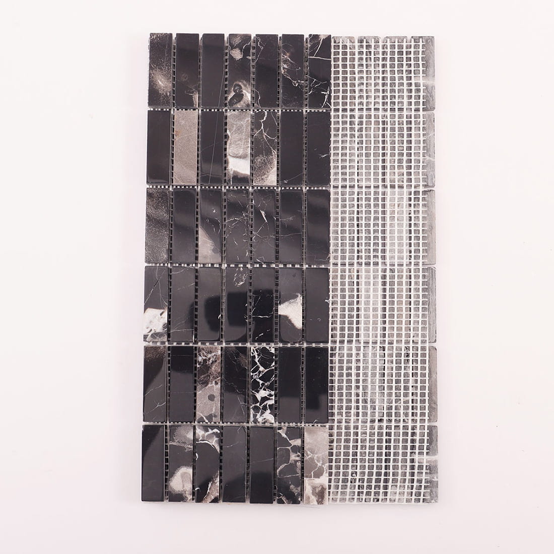 Back view of black marble strip mosaic sheet showing mesh backing