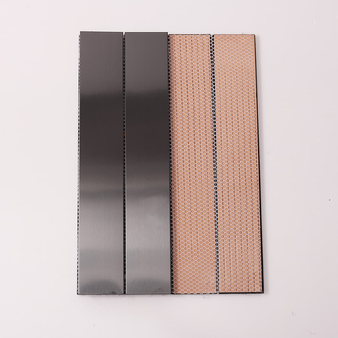 Front and back of black stainless steel tile showing mesh backing.