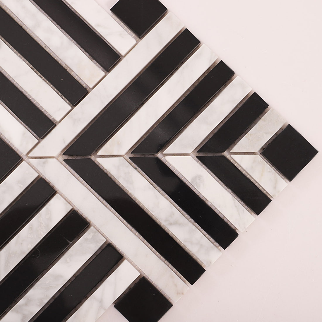 Close up of black and white chevron strips with a square end tile