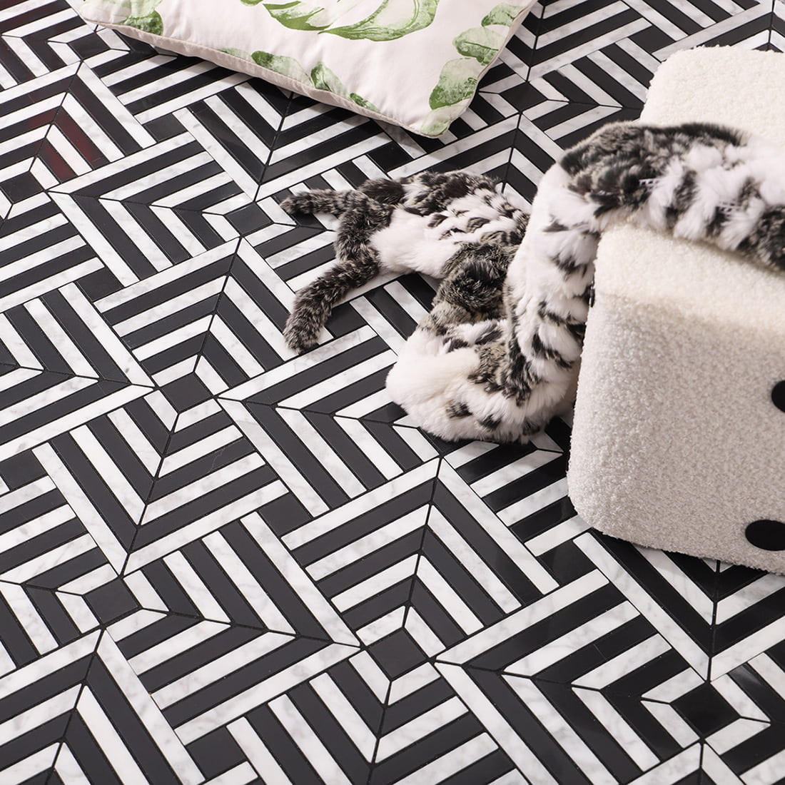 Lifestyle view of chevron mosaic floor with pillow and plush throw