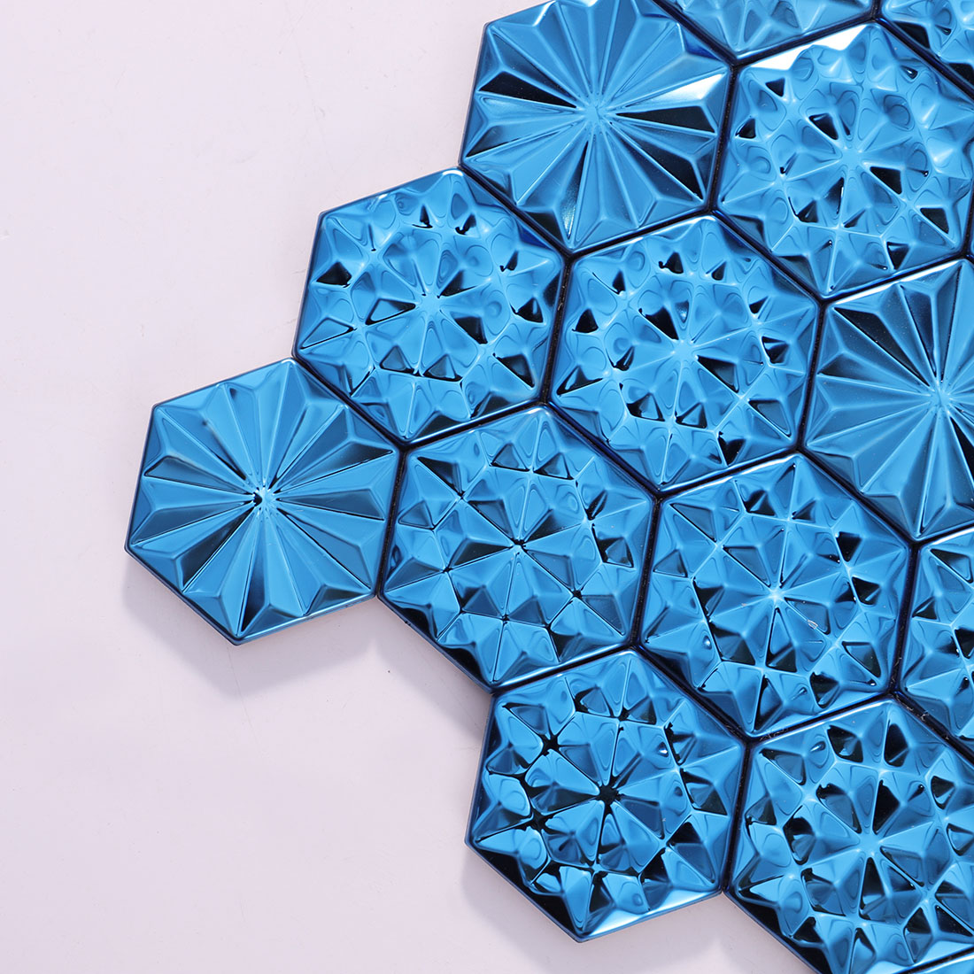 Corner detail of blue hexagon metal mosaic tiles with star patterns
