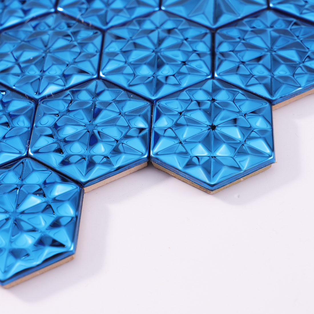 Angled view of blue hexagon metal mosaic tile sheet edge
