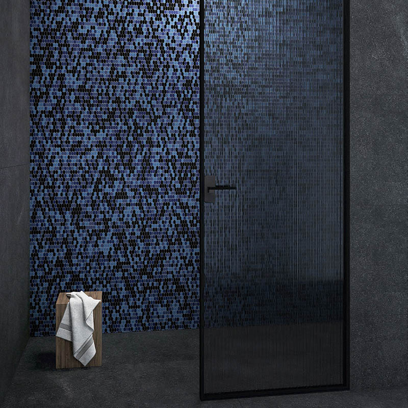Blue black long hexagon mosaic tile creating a bold bathroom feature wall