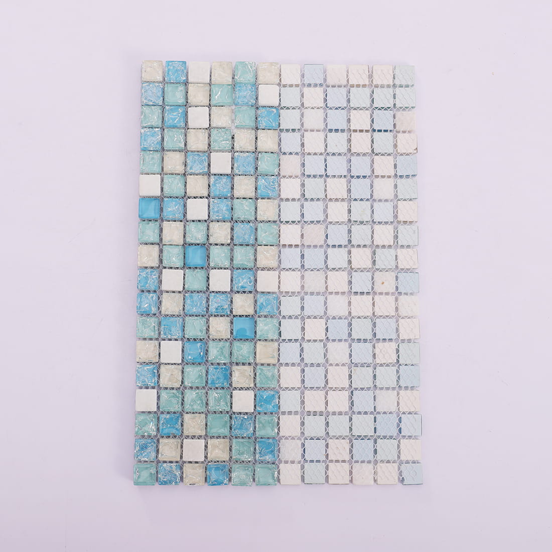 Blue glass and white stone square mosaic sheet folded to show mesh backing