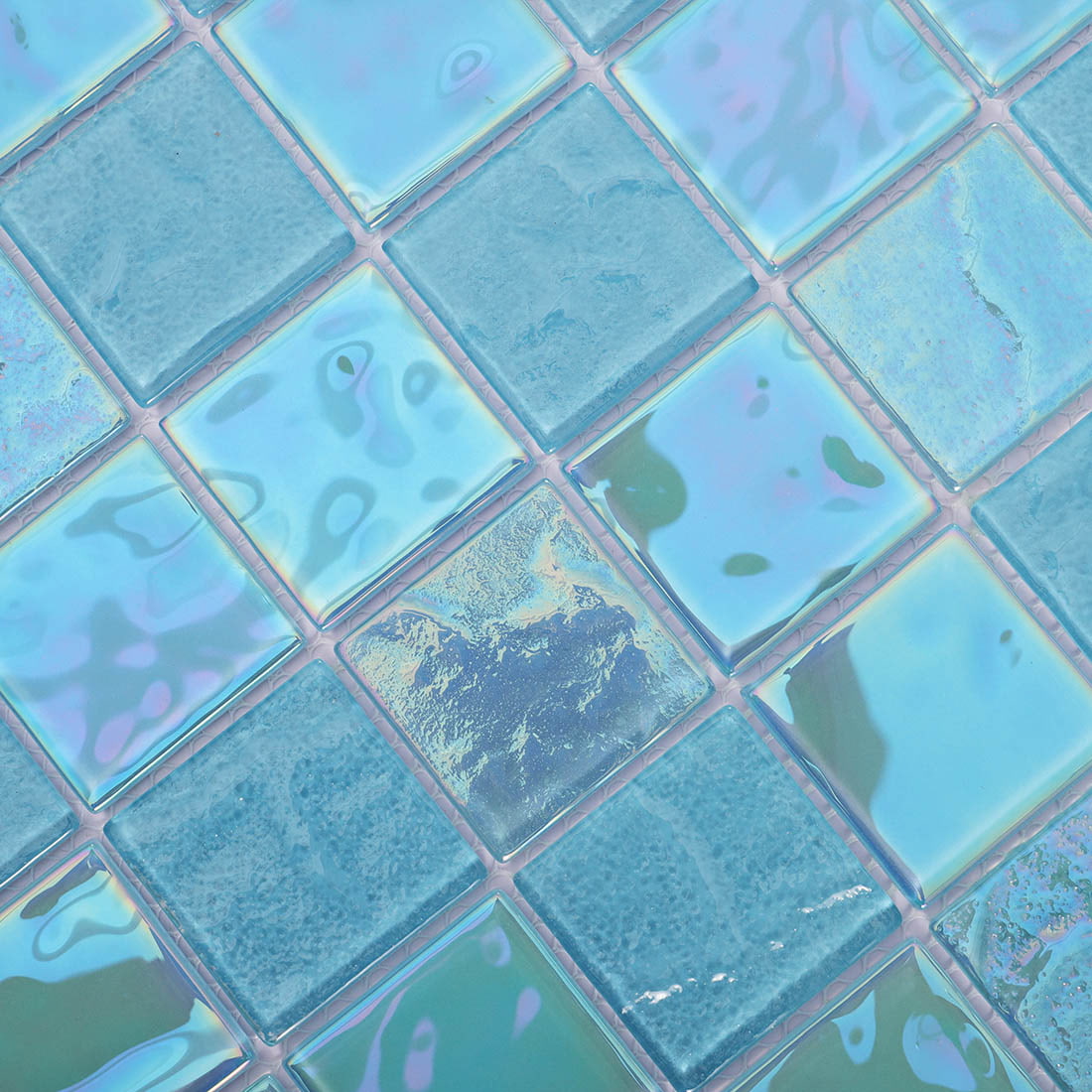 Close up of blue square glass mosaic tiles with glossy and textured finishes