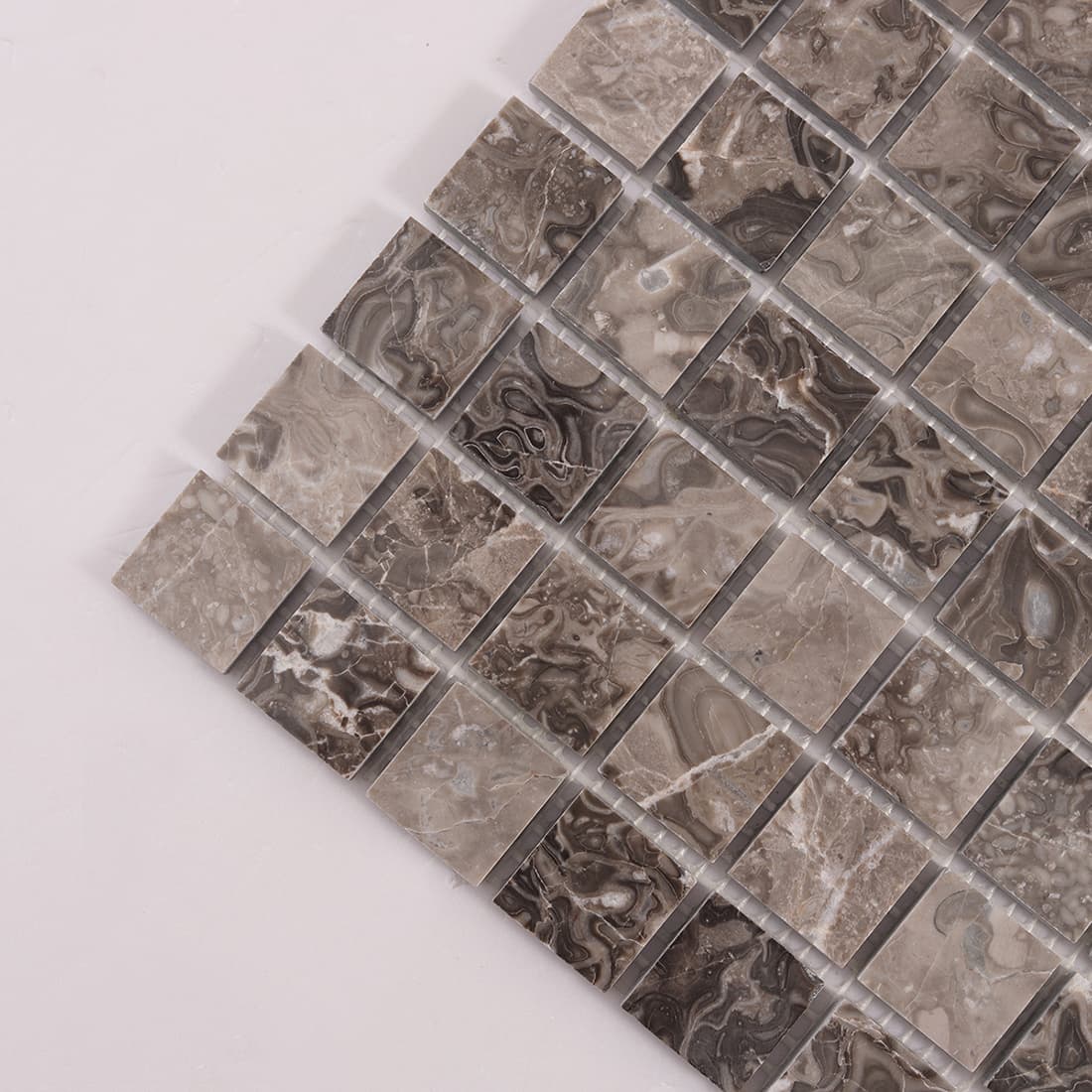 Diagonal corner view of brown marble square mosaic tiles