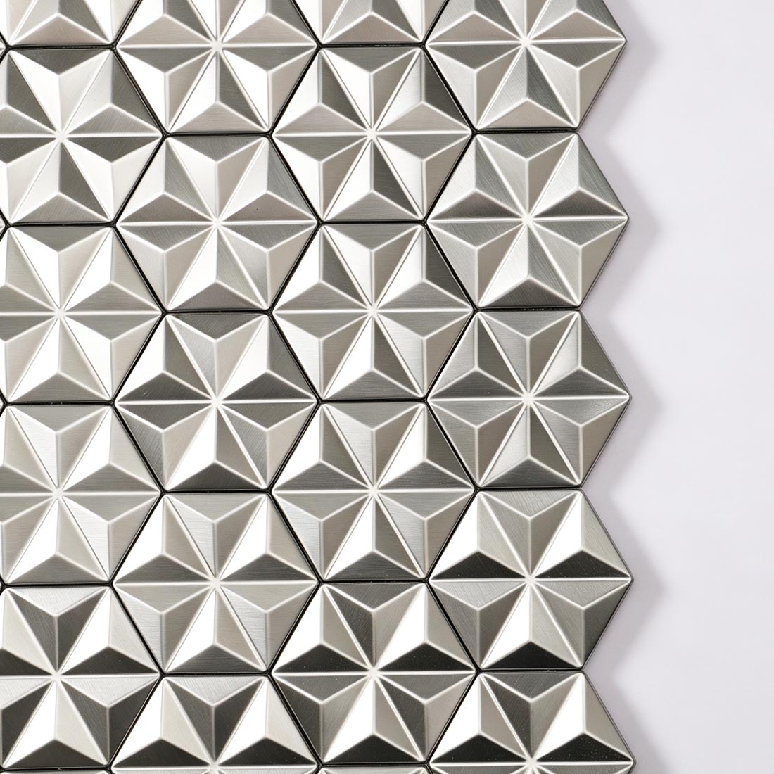 Close-up texture of brushed silver geometric hexagon metal mosaic tiles