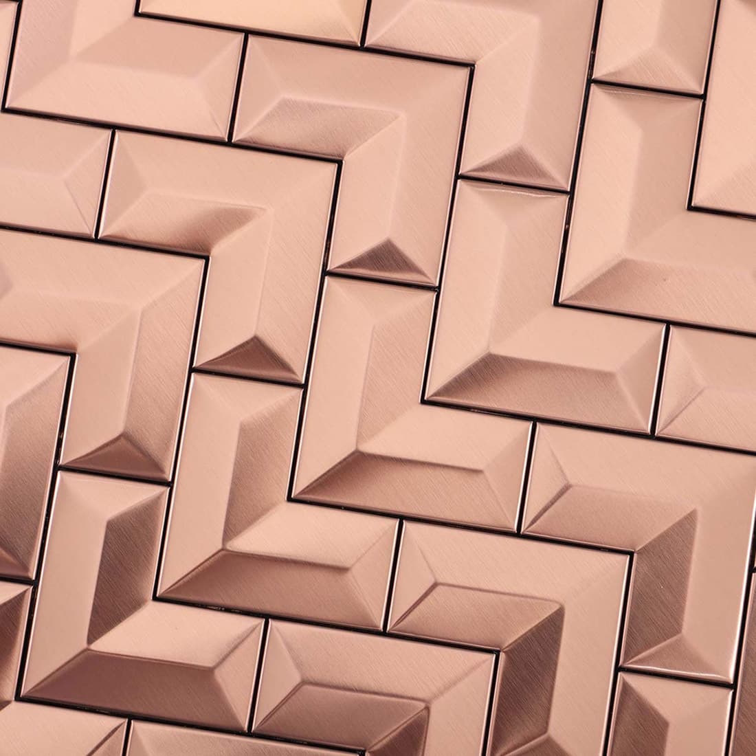 Detailed view showing the brushed texture of rose gold chevron metal tiles.