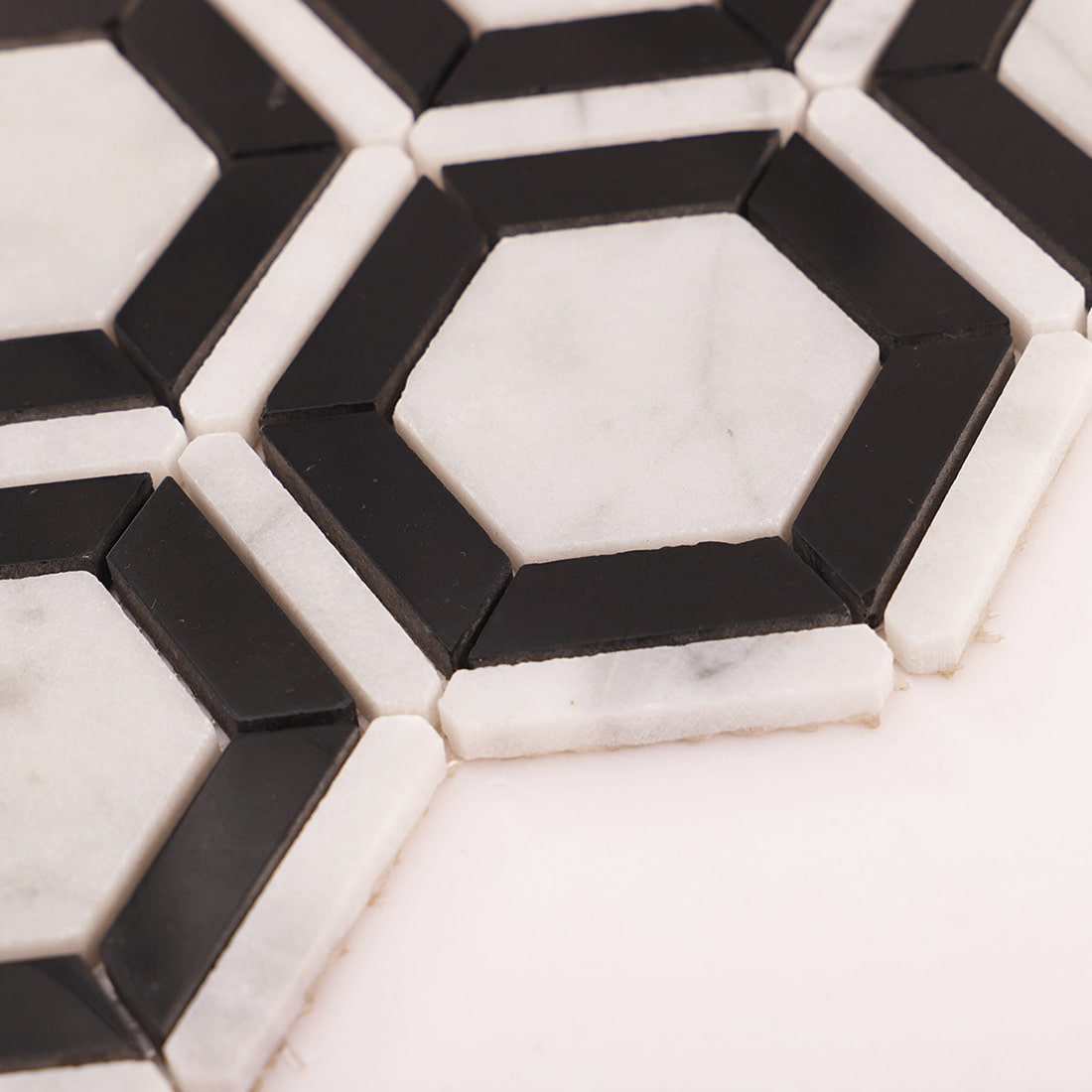 Close up showing edge thickness of Carrara White and Nero Marquina marble pieces