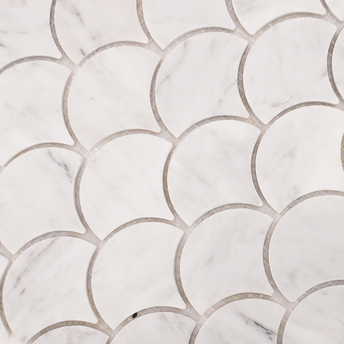 Macro view of Carrara white marble fish scale mosaic highlighting smooth surface and edges