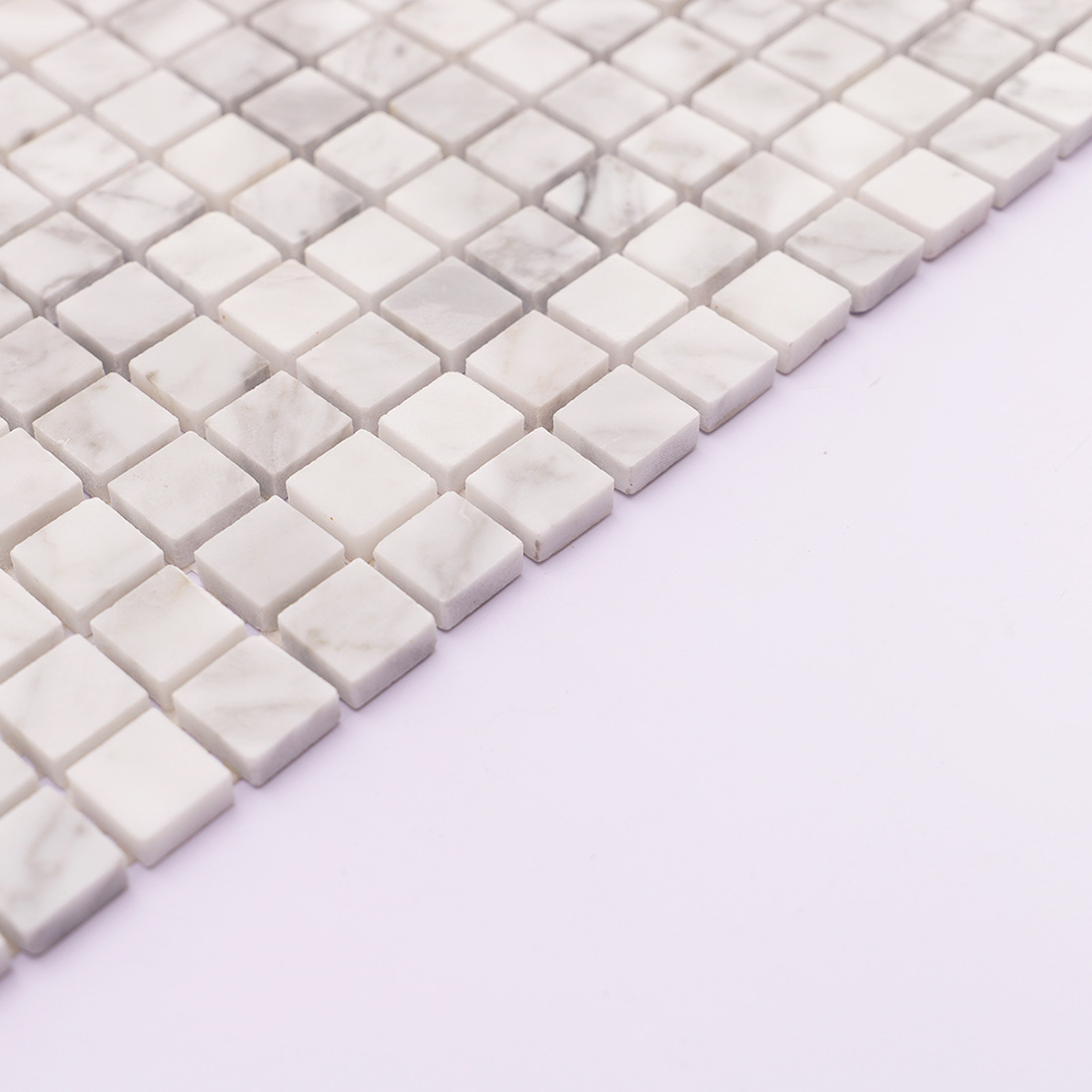 Side edge of Carrara white square marble mosaic tile with natural stone texture