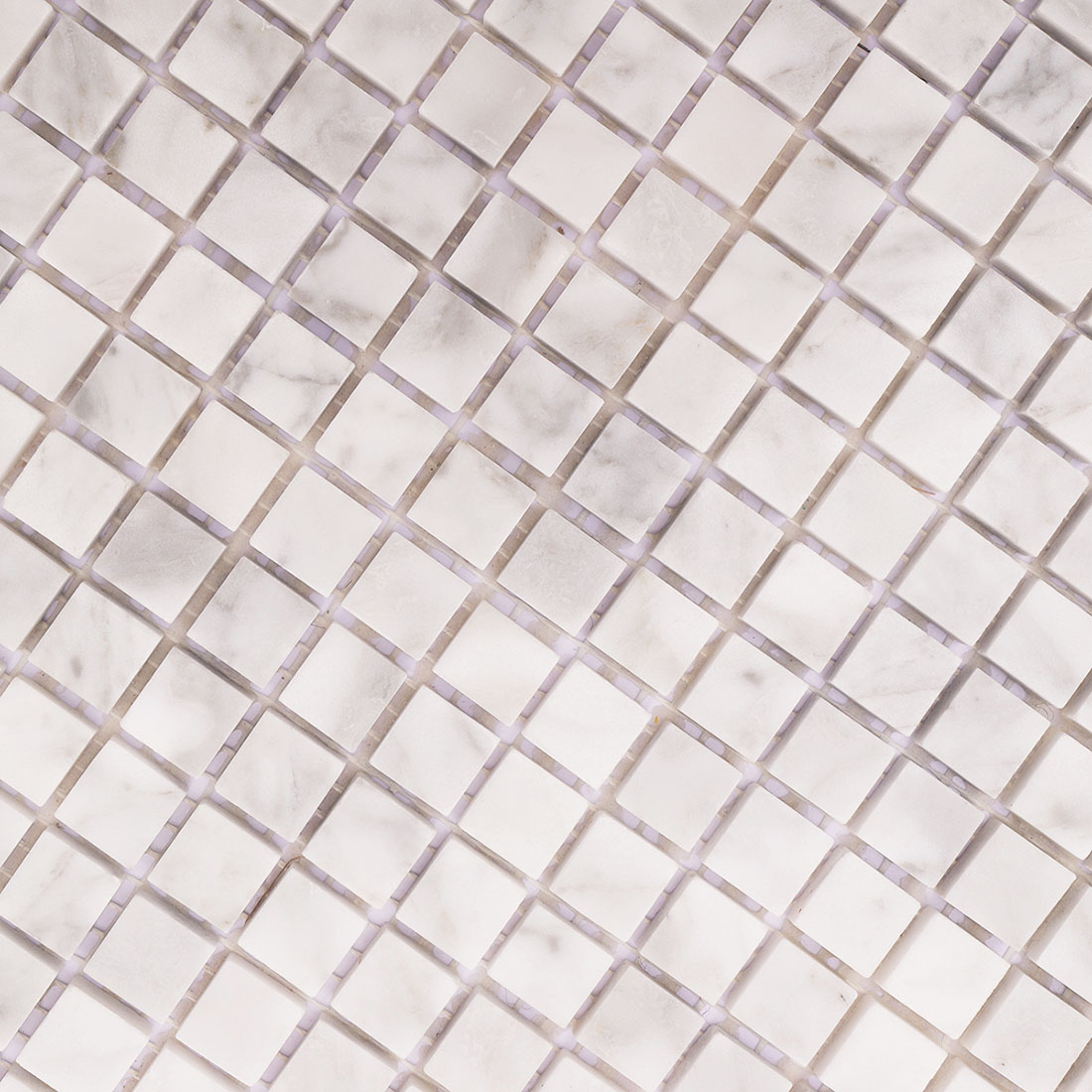 Close-up of Carrara white square marble mosaic tiles with natural veining