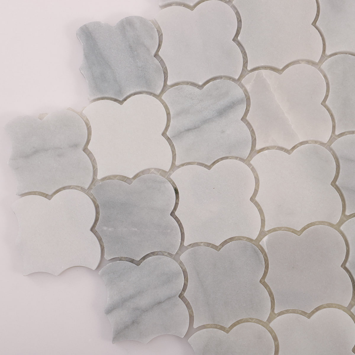 Corner close up of Carrara white cloud shaped marble mosaic pattern