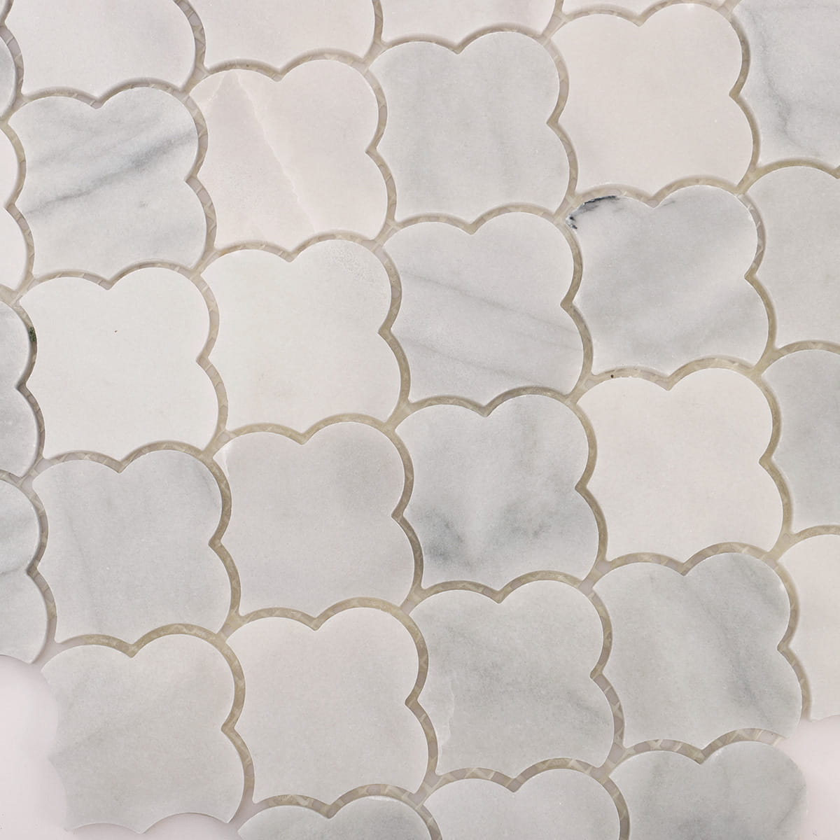 Thickness detail of Carrara white cloud shaped marble mosaic pieces