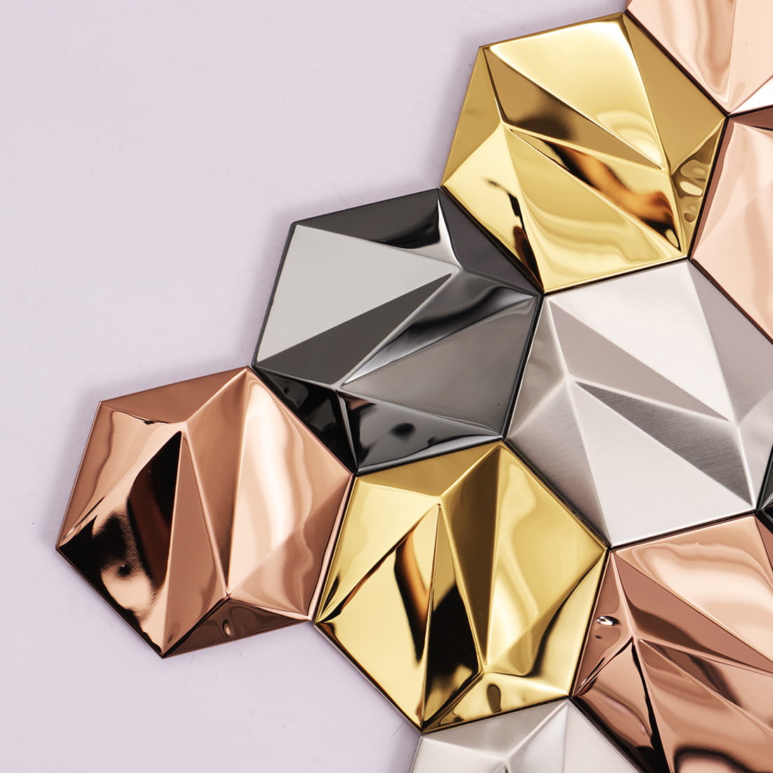 Close-up of geometric 3D tiles showing the sharp angles and reflective metallic surfaces.